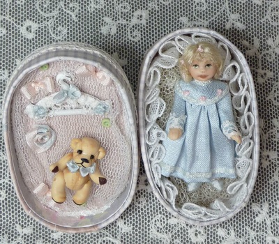 Doll in an oval box